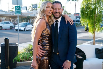 Josh Altman and Heather Altman hugging in front of their new office.