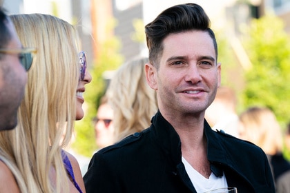 Josh Flagg smiling while talking to Tracy Tutor and Matt Altman.