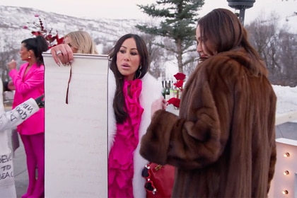 Angie Katsanevas showing Meredith Marks her scroll.