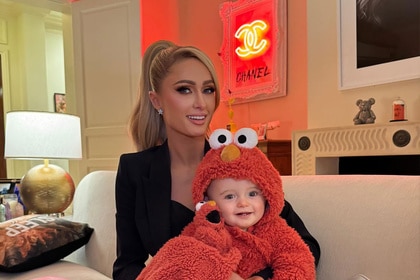 Paris Hilton and Phoenix Barron smiling together in a living room.