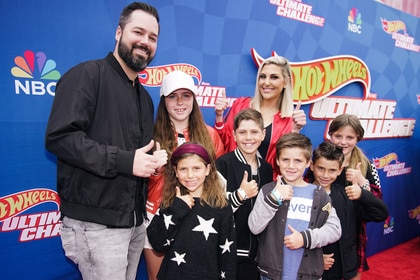 Travis Mullen and Gina Kirschenheiter with their children on red capet for "Hot Wheels: Ultimate Challenge"