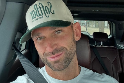 Carl Radke posing in a car with a hat on.