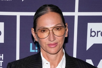 Jenna Lyons posing in front of a step and repeat while at the Watch What Happens Live clubhouse in New York City.