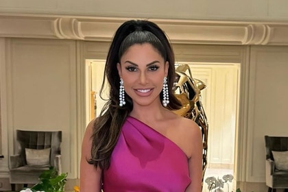 Jennifer Aydin posing indoors wearing a pink gown.