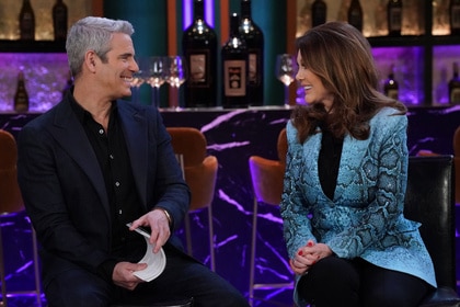 Andy Cohen and Lisa Vanderpump having a conversation together at a Vanderpump Rules reunion