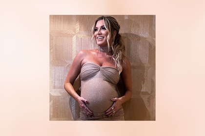 Lindsay Hubbard holding her baby bump and posing in a gown.