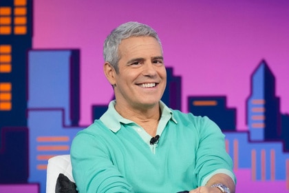 Andy Cohen smiling while onstage at Watch What Happens Live.