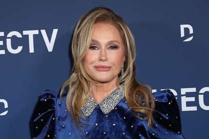 Kathy Hilton posing in front of a step and repeat.