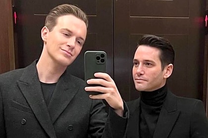 Josh Flagg wearing a black turtleneck and blazer with Kelton also wearing a black blazer