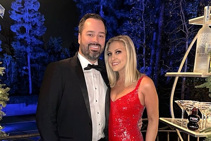 Travis Mullen and Gina Kirschenheiter at a holiday party together