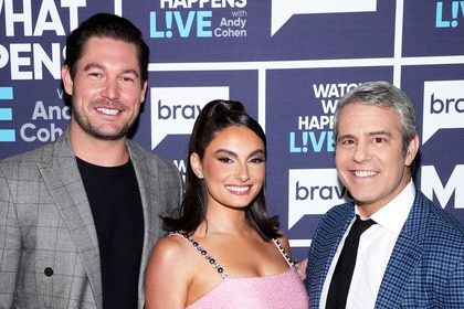 Andy Cohen, Paige DeSorbo, and Craig Conover posing together in front of a step and repeat.