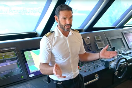 Captain Jason Chambers wearing his captain uniform on his charter yacht