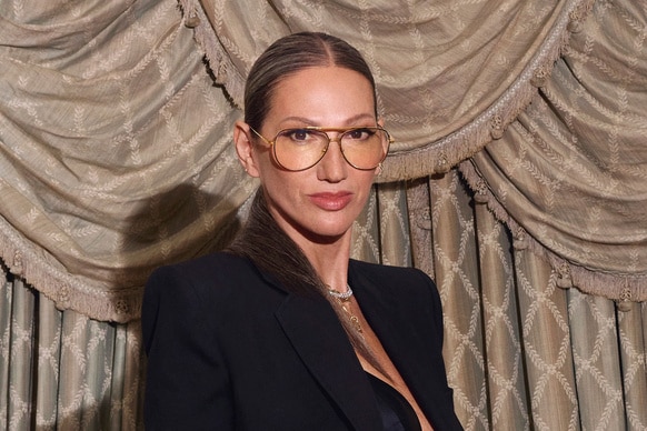 Jenna Lyons posing in front of a curtain in a cropped blazer.