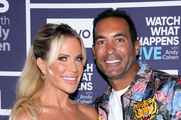 Jennifer Pedranti and Ryan Boyajian posing in front of a step and repeat.