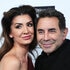 Paul Nassif and Brittany Nassif posing together in front of a step and repeat.