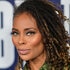 Eva Marcille smiling in front of a step and repeat.