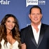 Dolores Catania and Paulie Connell smile in front of a blue backdrop.