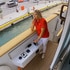 Captain Sandy Yawn driving the Mustique yacht and talking on the radio.