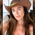 Kyle Richards wearing a cowboy hat and a black bathing suit