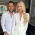 Josh Altman and his wife Heather Altman wearing white outfits in the door of their home.