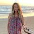 Ashley Jacobs wearing a colorful dress at the beach