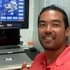 Colin Macrae in front of a computer while sailing on a yacht