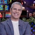 Andy Cohen smiles in a blue blazer on the set of Watch What Happens Live