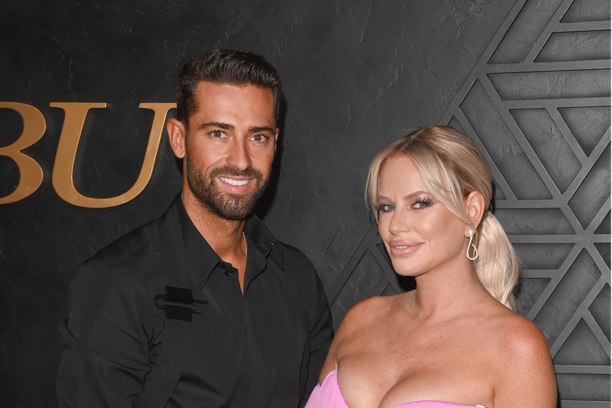 Caroline Stanbury and Sergio Pendas pose for a photo together while on a red carpet.