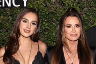 Kyle Richards and Alexia Umansky posing next to each other at a red carpet event.