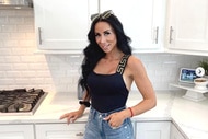 Rachel Fuda wearing jeans and black tank top in a kitchen.