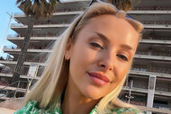Courtney Veale takes a selfie wearing a light green and white printed top while in the French Riviera.