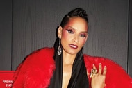 Racquel Chevremont wearing a black dress and a red fur coat
