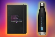 A notebook and a water bottle in front of a colorful background.