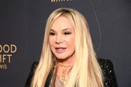 Adrienne Maloof posing in front of a step and repeat.