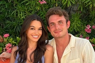 James Kennedy and Ally Lewber smile together in front of plants.