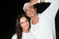 Tom Sandoval and Victoria Lee Robinson posing and smiling together in white outfits.