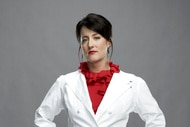 Naomi Pomeroy in her white chef's coat in front of a grey backdrop.