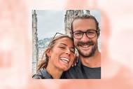 Aesha Scott and Scotty Dobbo posing together in front of a cathedral.