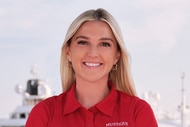 Carrie O'Neill smiling on the Mustique yacht in her uniform.