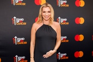 Lindsay Hubbard posing in front of a step and repeat with a baby bump.