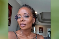 Eva Marcille in her living room wearing glasses