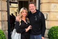 Alexis Bellino and John Janssen pose together outside of a hotel