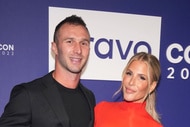 Tracy Tutor and Erik Anderson smiling together in front of a step and repeat.