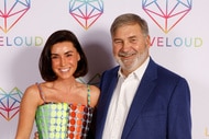 Bronwyn Newport and Todd Bradley smiling together in front of a step and repeat.