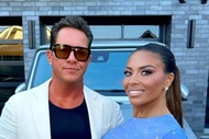 Dolores Catania and Paul Connell smiling next to each other in front of an SUV.