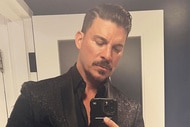 Jax Taylor posing in a suit in a mirror.