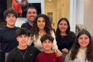 Jennifer Aydin smiling with her family inside their home.