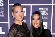 Lisa Barlow and Molly Sims smiling in front of a step and repeat at the Watch What Happens Live clubhouse in New York City.