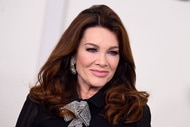 Lisa Vanderpump smiling in front of a step and repeat.