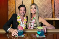 Josh Flagg and Denise Richards at a bar together wearing leis